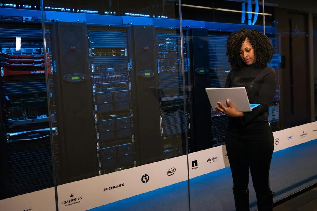 Data specialist working beside server racks